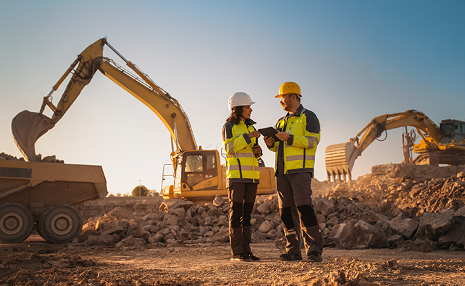man and woman standing in a contruction zone talking