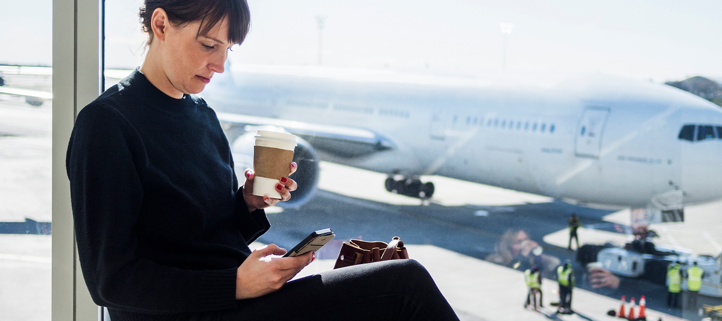 Woman looking at phone at airport
