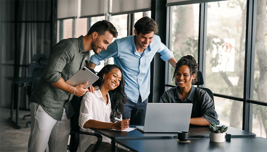 A group of people having a meeting around a desk
