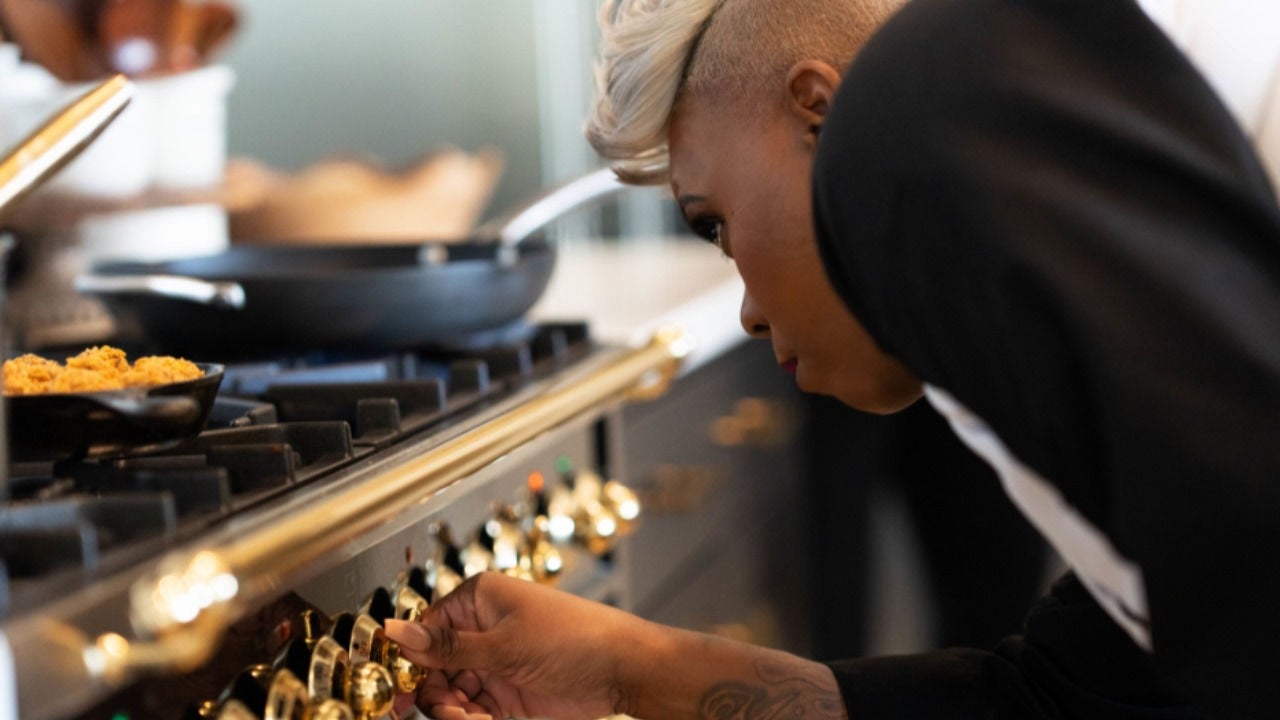 Latoya Larkin adjusts the temperature on the stove.