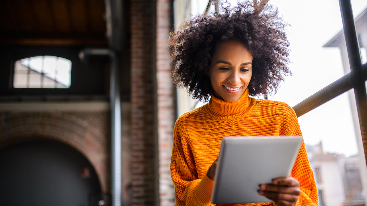 Woman on tablet reviewing credit documents