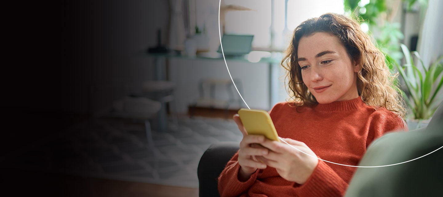 Žena gleda u mobitel ako bi pregledala uvide o rizicima.