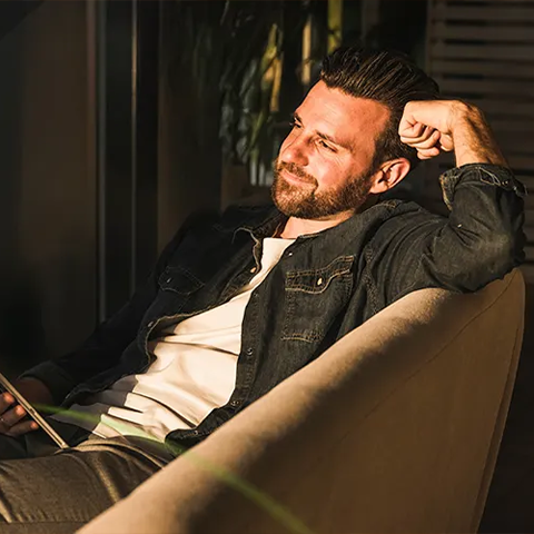 Man smiling holding his phone