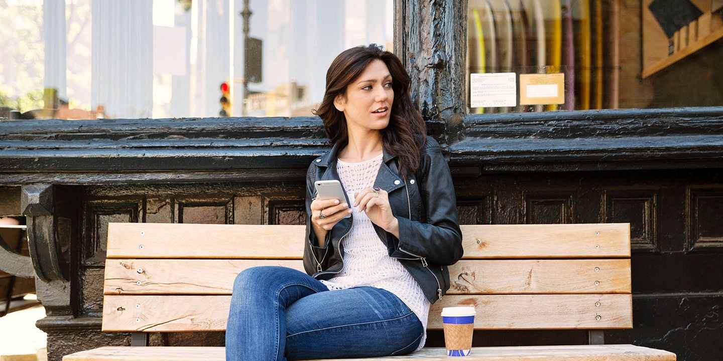 Woman on bench using smartphone