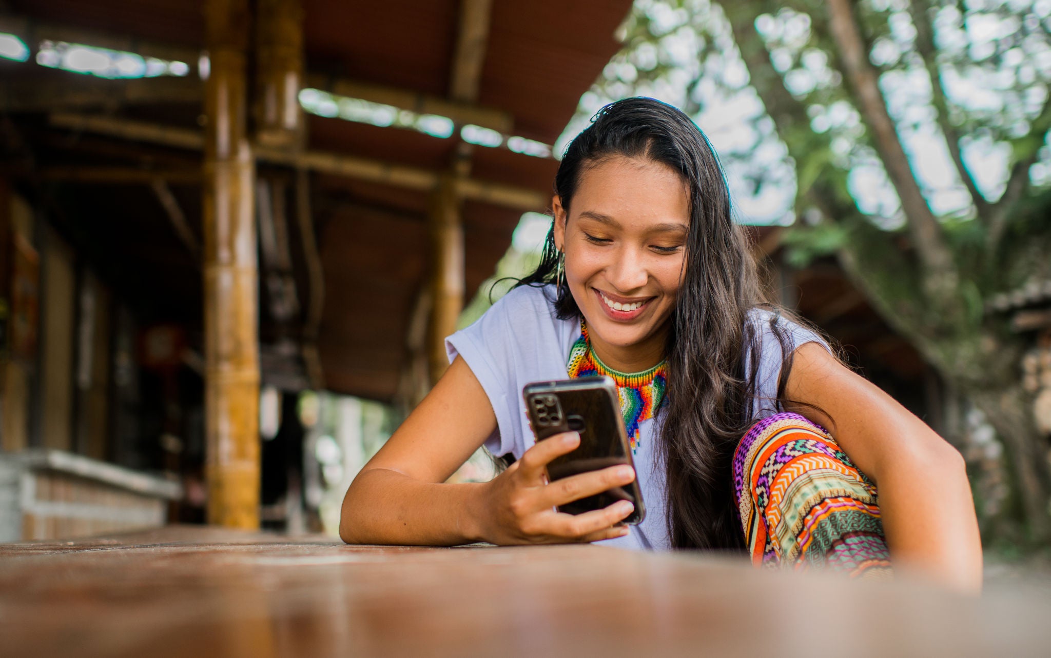 Woman smiling while scrolling her phone