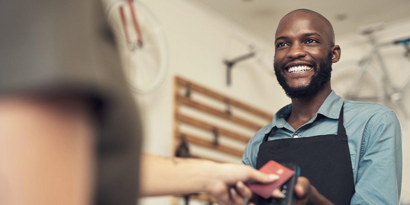 A man accepting a payment at a small business