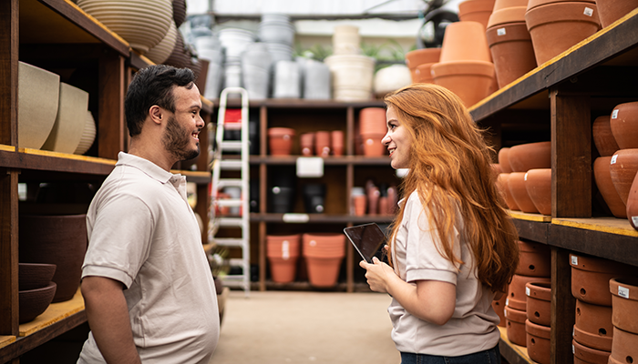 Man and woman talking in a store aisle