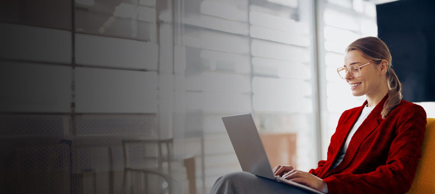 smiling woman working on a laptop
