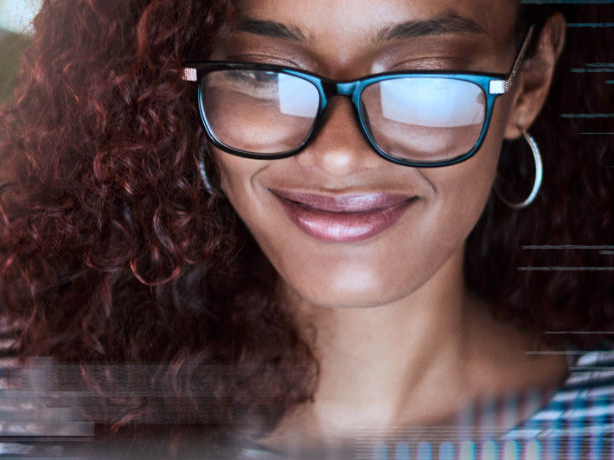 Woman staring at computer smiling