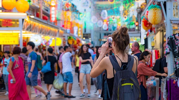 Woman in street market taking picture