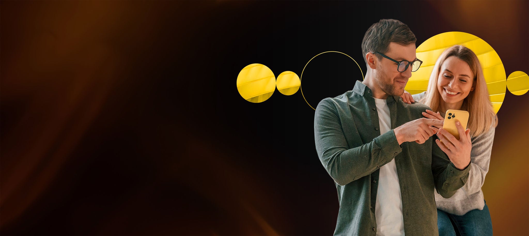 Two people looking at a phone