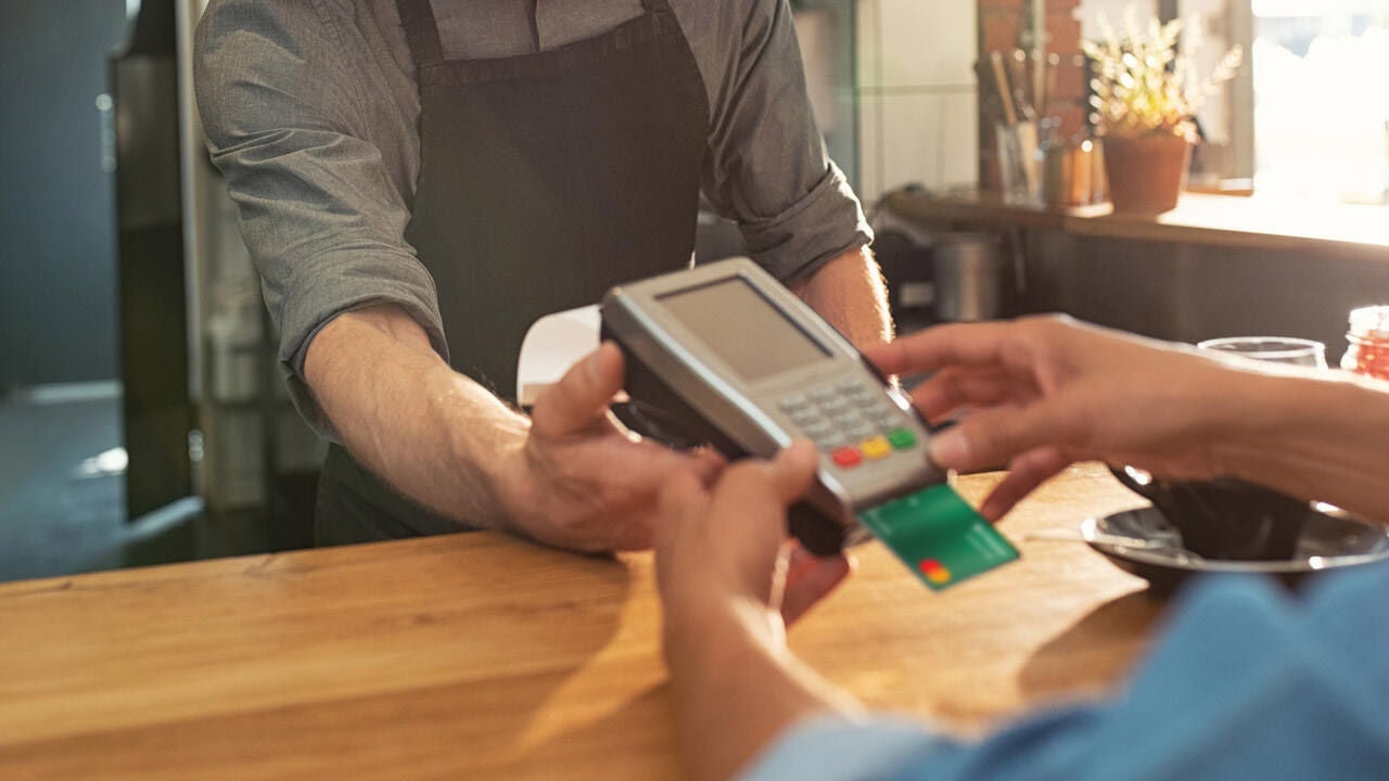 Waiter accepting payment by card.