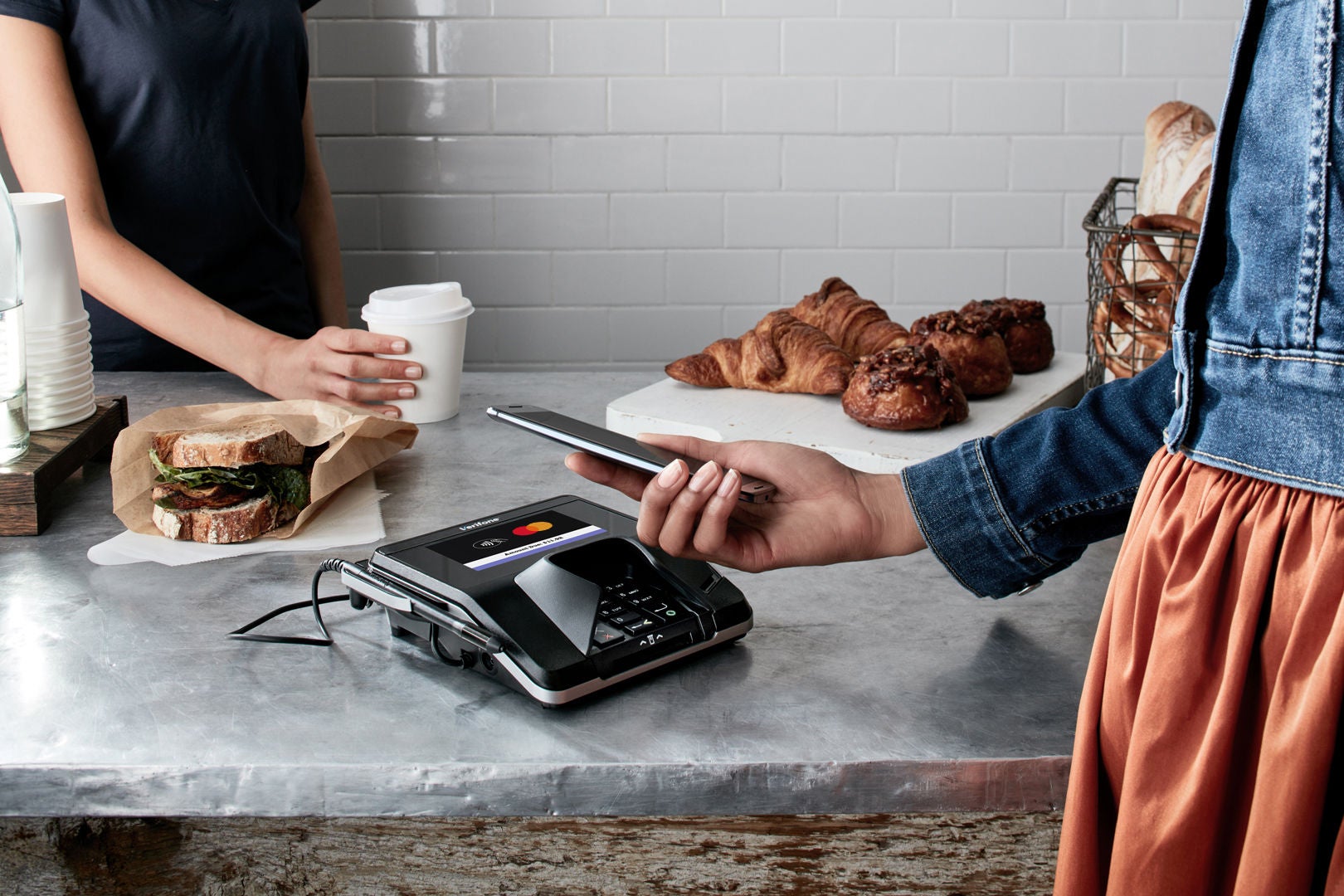 Customer completing a transaction at a coffee shop