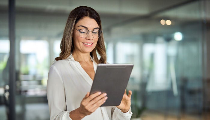 Woman analyzing data on her tablet