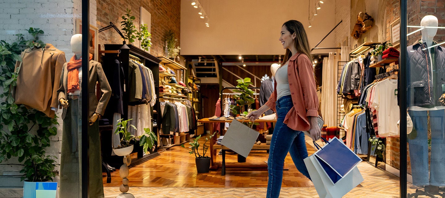 Woman walking past a storefront