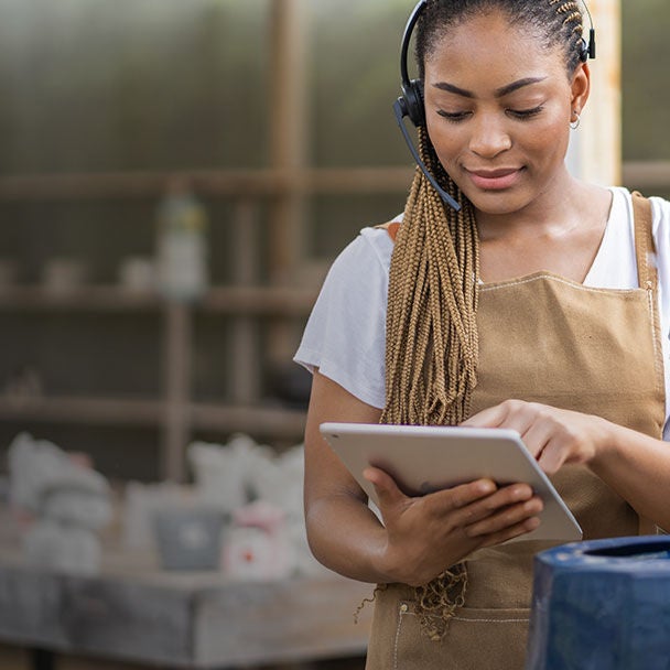 Woman in workshop using a tablet.