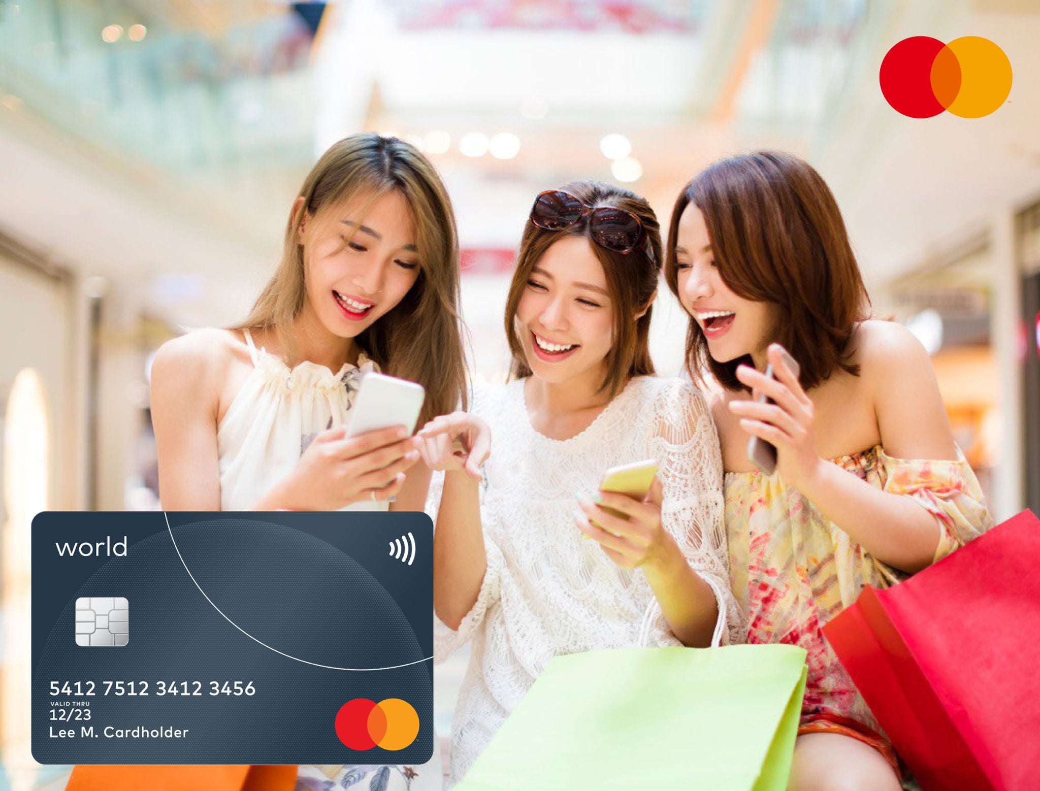 Three young women look at their phones together and laugh in a shopping mall, holding shopping bags, with a dark payment card shown in the lower left.