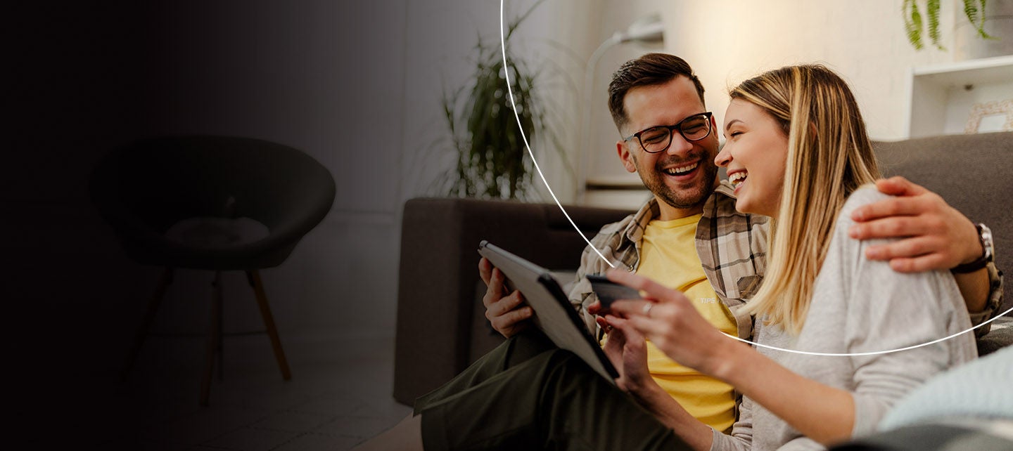 Žena i muškarac gledaju u laptop računar i istražuju opcije i pogodnosti World kartice.