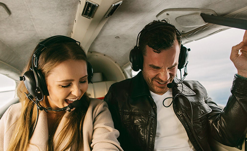 Happy woman and man on a helicopter