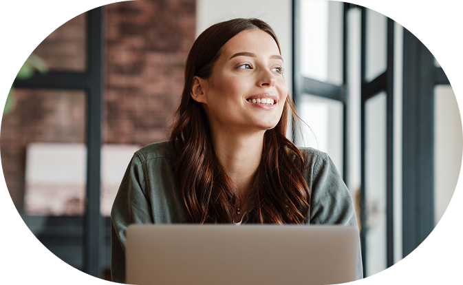 Woman smiling in front of her laptop