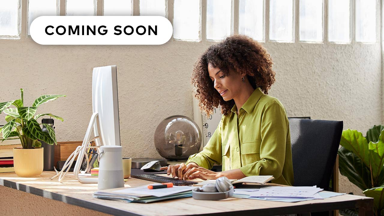 Woman in a green blouse working in an office.