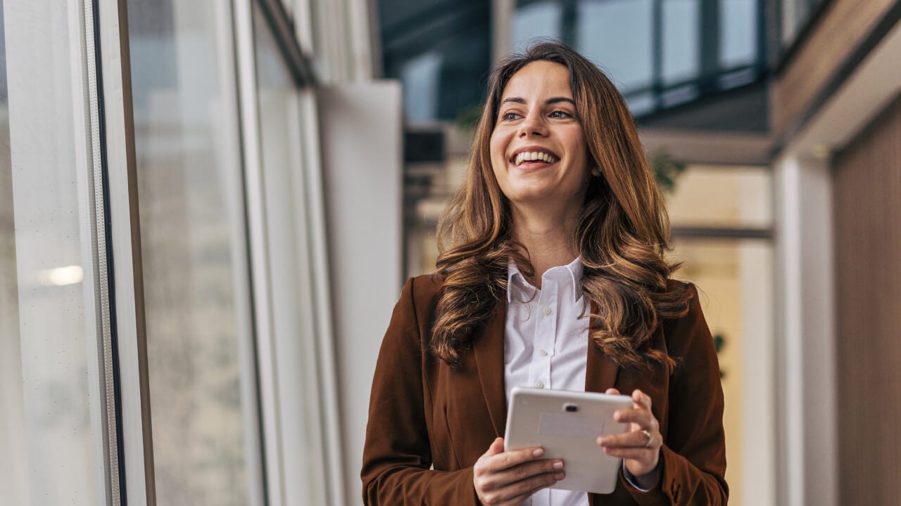 Business professional holding tablet in hand