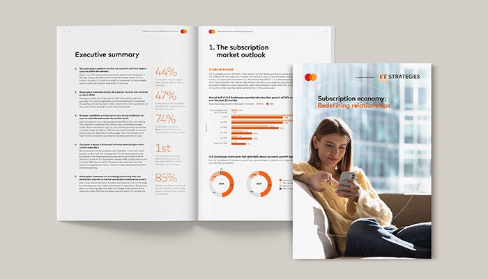 Woman looking at phone on the couch report cover