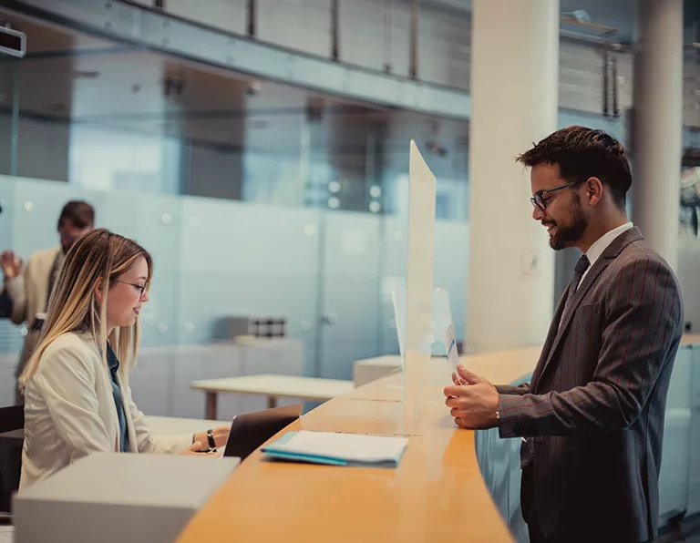 Man talking to a lady behind a counter