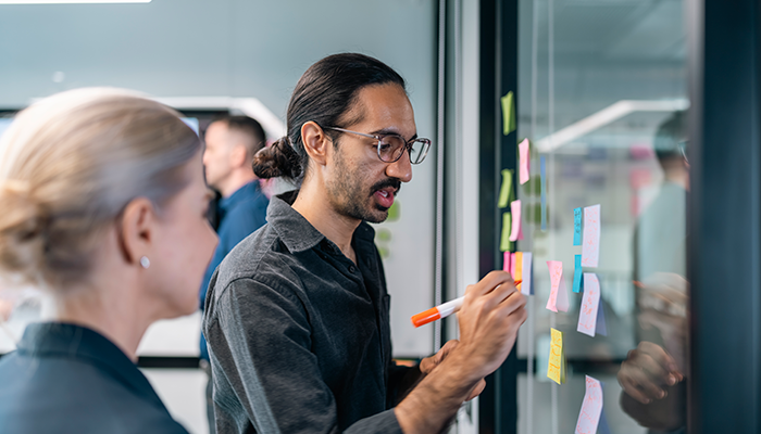 Two workworkers disucssing innovation