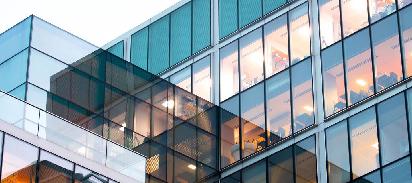 A modern building with multiple windows and a large glass facade. 
