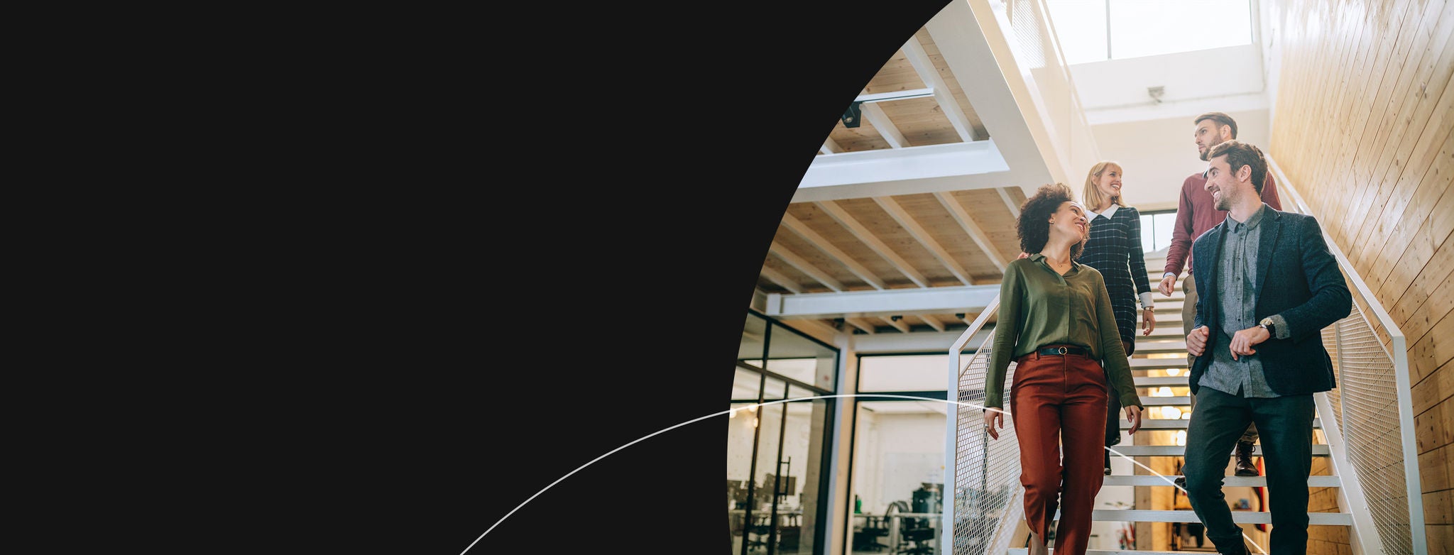 People chatting and walking down office stairs