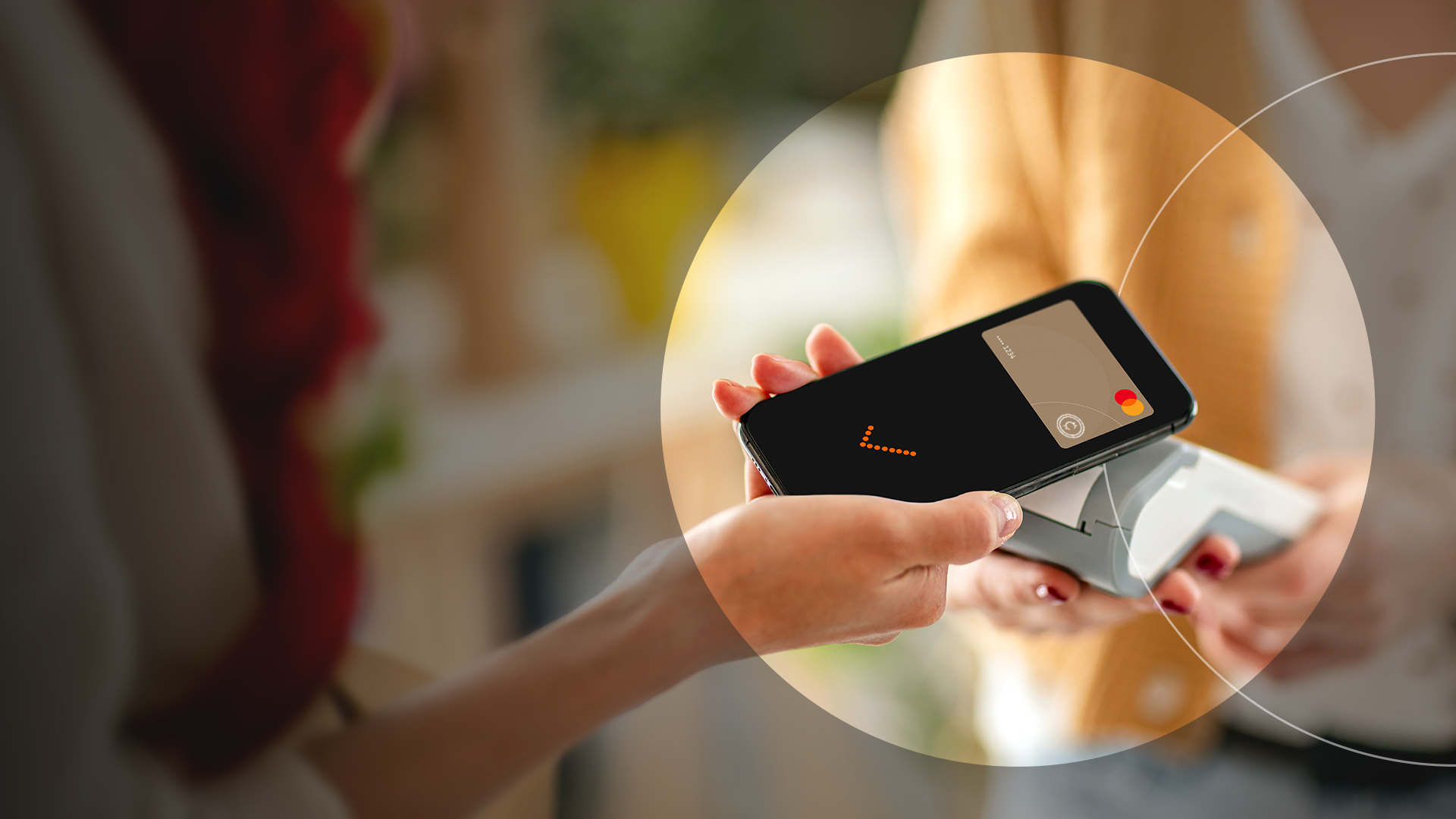 Woman's hand paying for item with phone