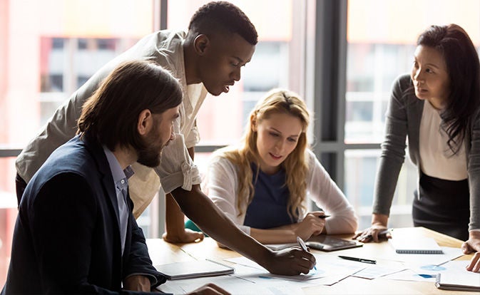 Group at a table discussing reports