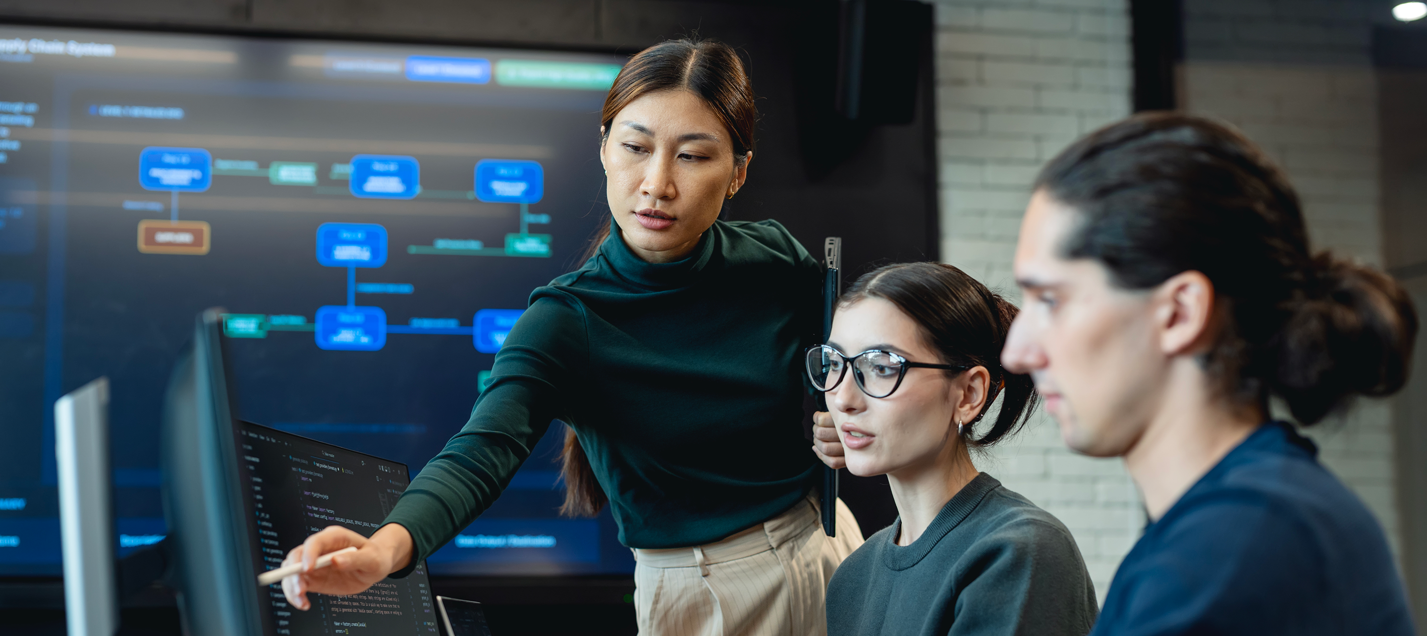 Group of coworkers looking at tech updates