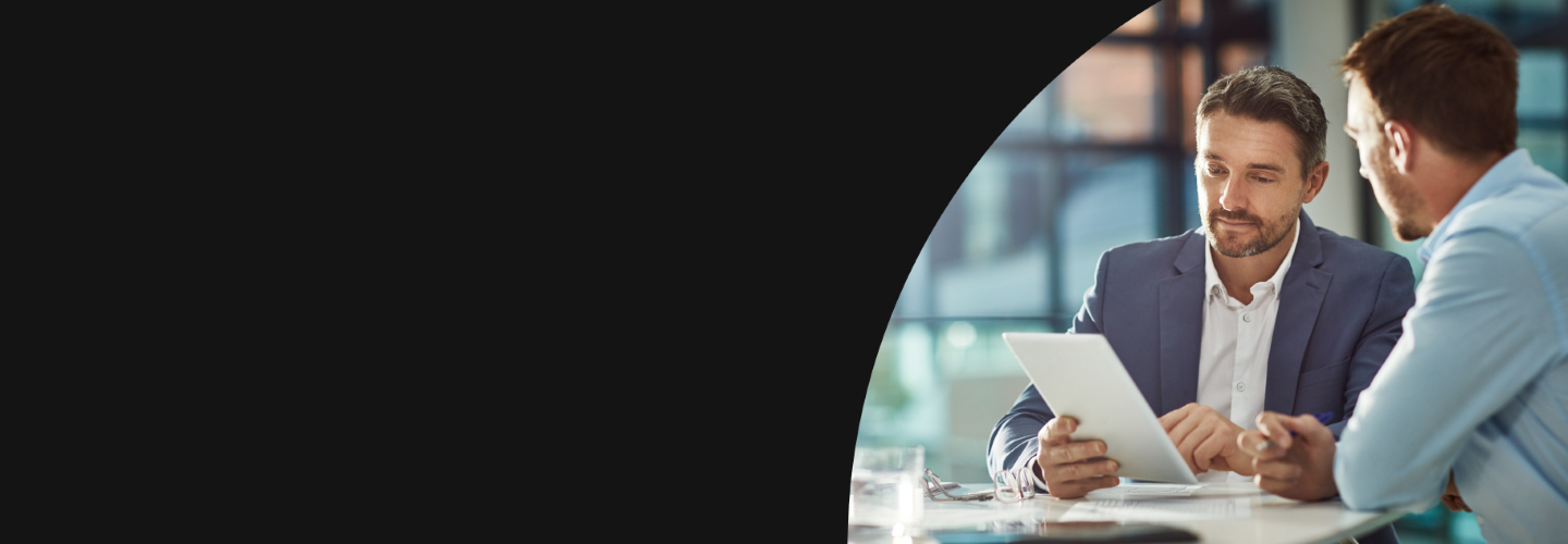 Two male coworkers reviewing a document