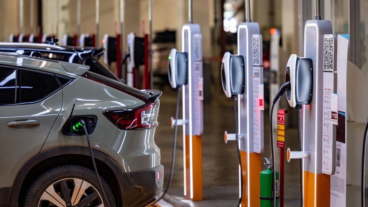 An EV being charged at a row of chargers. 