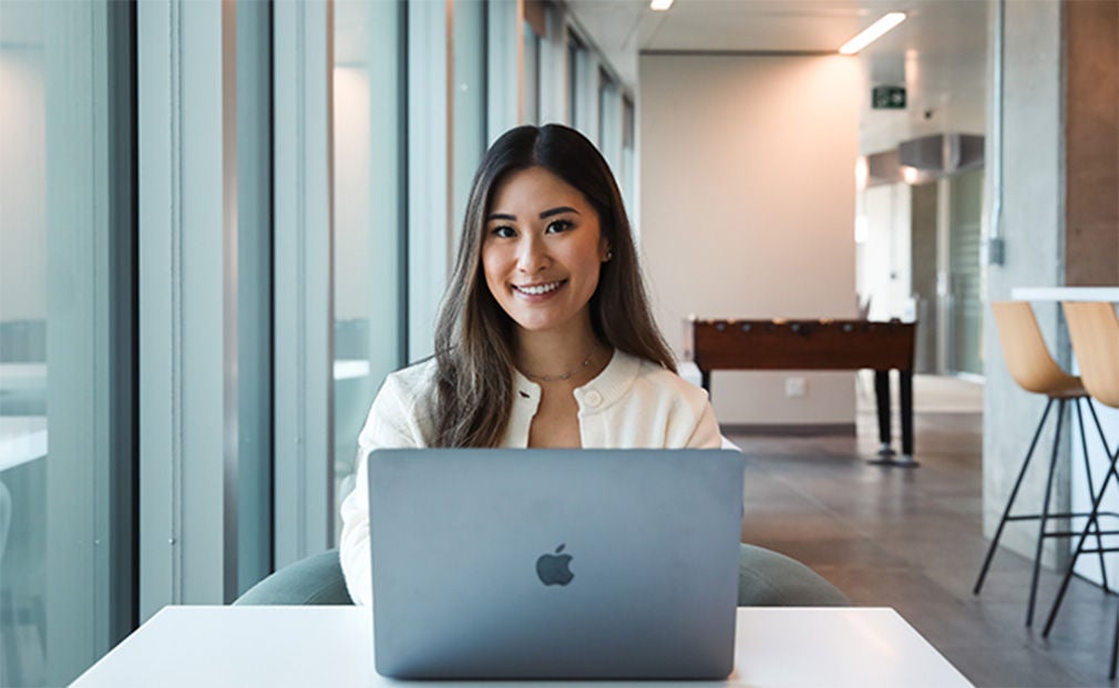 Woman smiling while using her computer