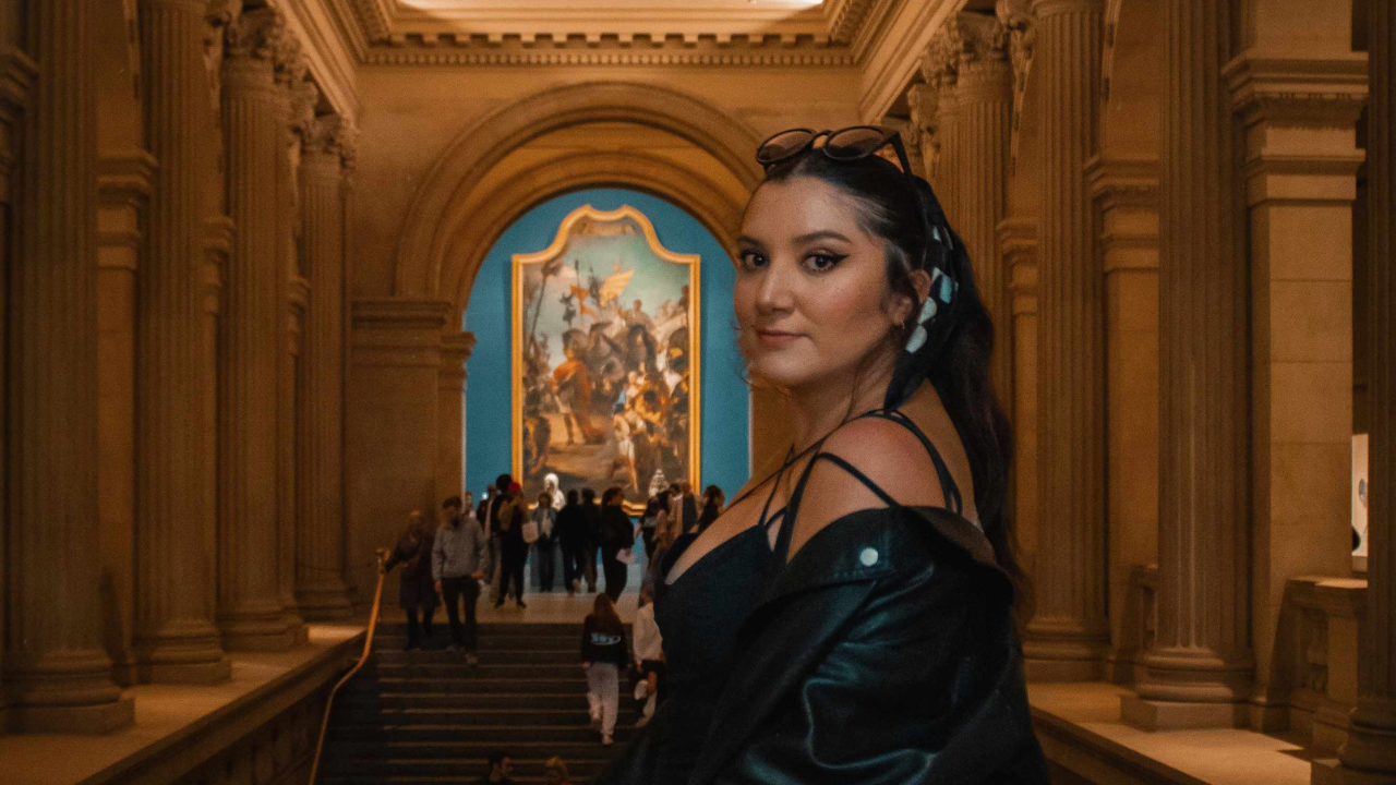 Mariana Trujillo in a museum with columns behind her. 