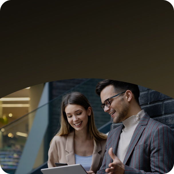 Man and woman looking at  tablet.