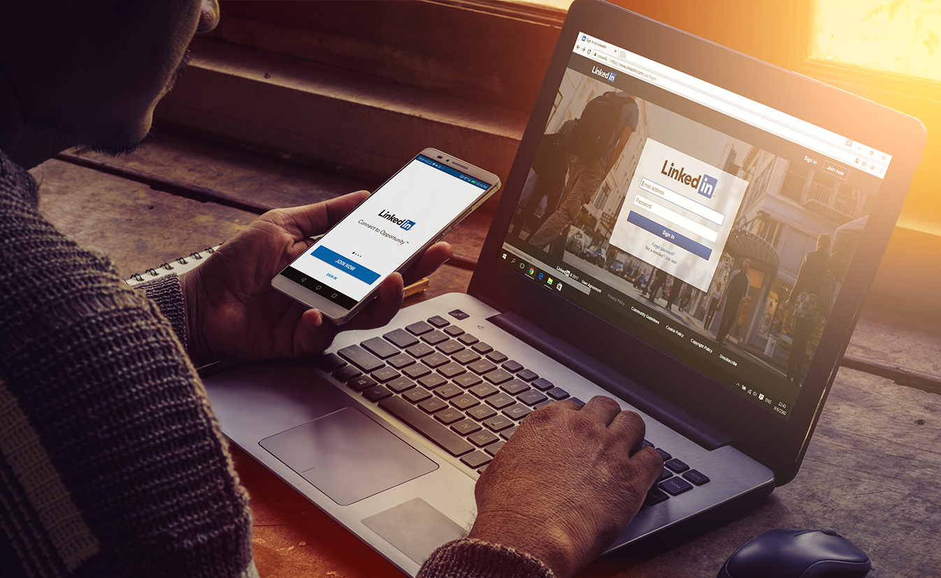 zoomed in picture of laptop with person logging into linkedIn