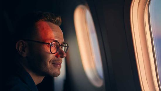 Man looking out aeroplane window
