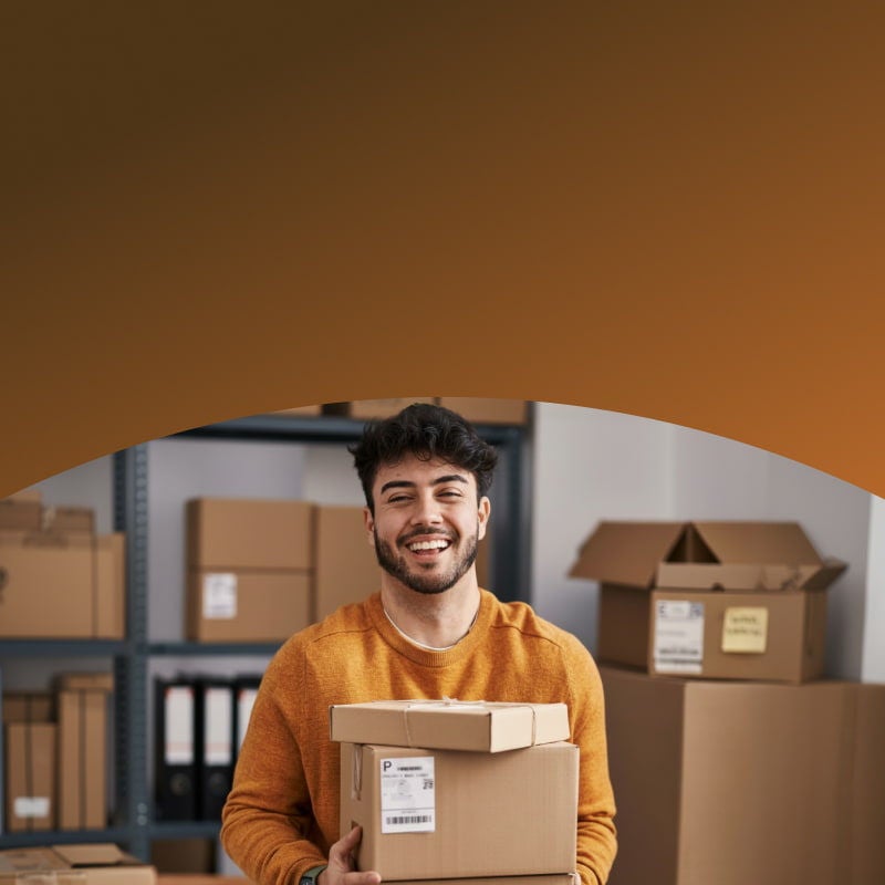happy man holding cardboard boxes