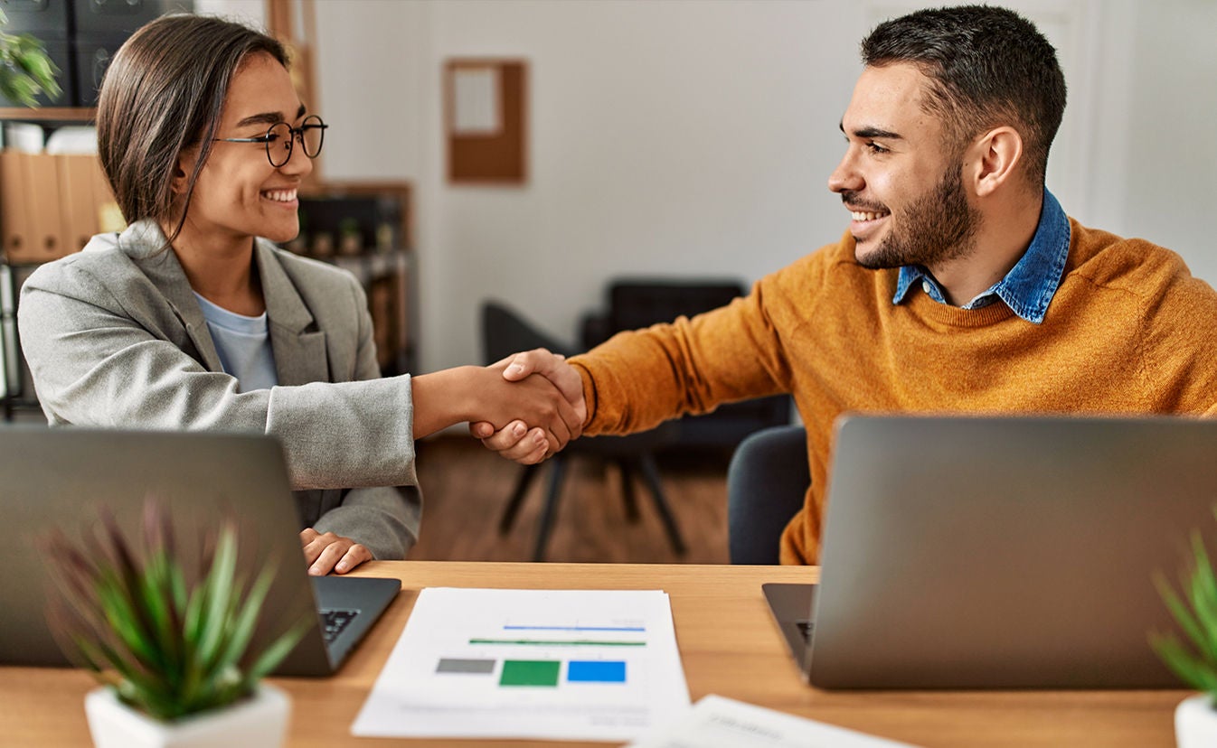 Two business workers shaking hands.