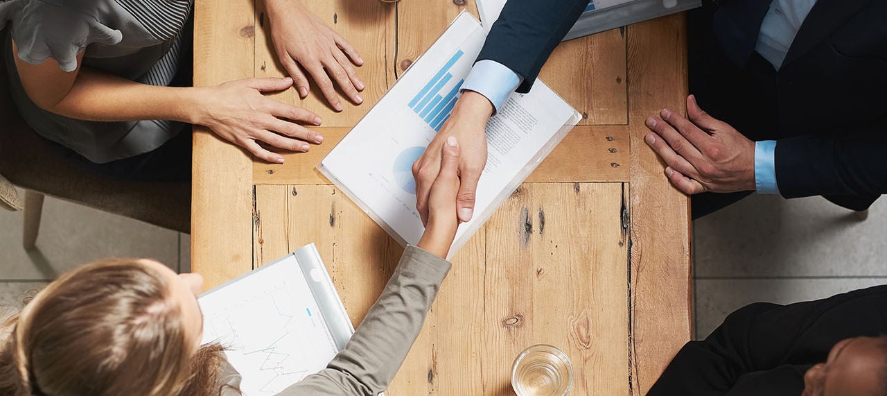 Close-up of cashier’s hands pulling a printed receipt from a POS system