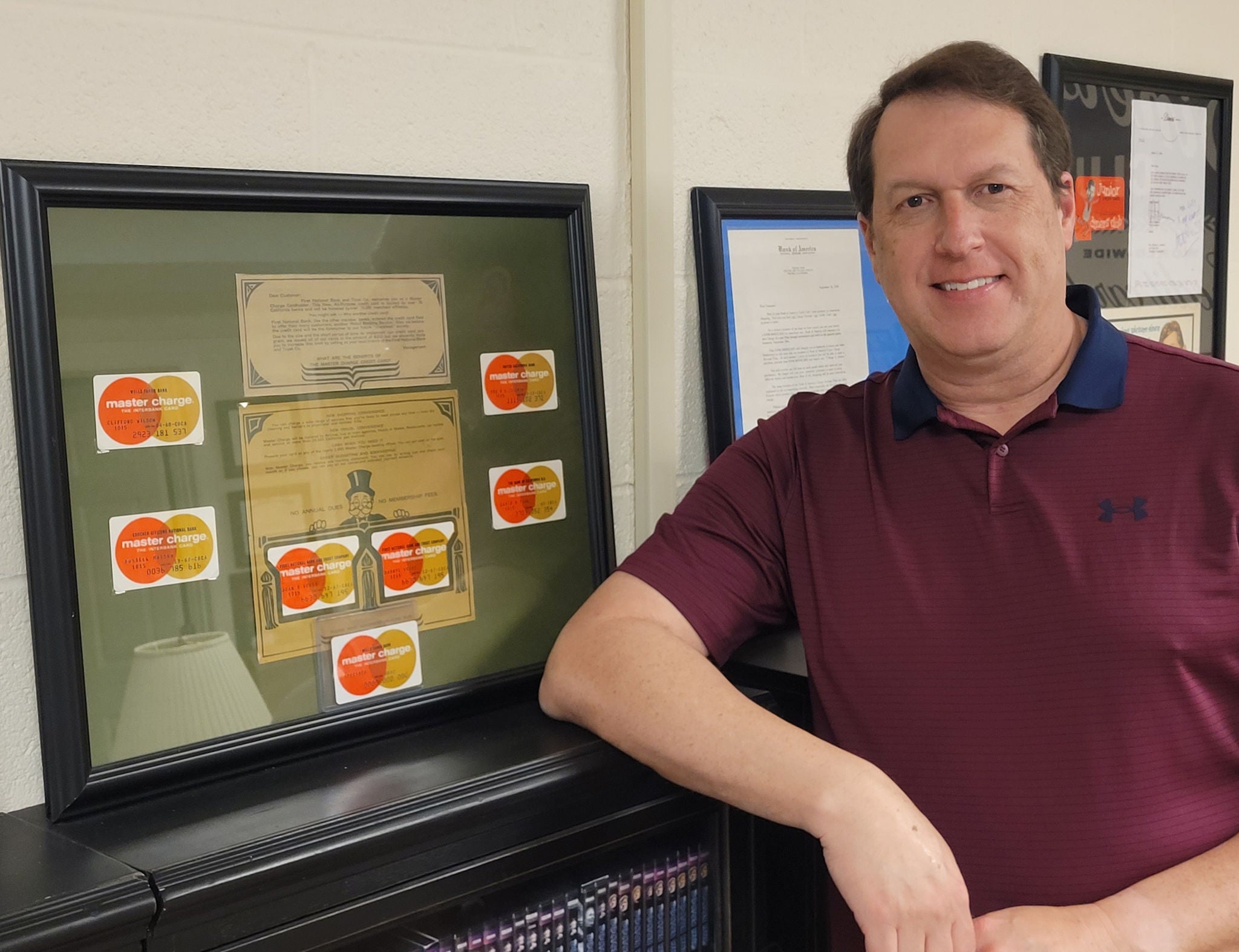 Scott Nimmo in front of his collection of Master Charges. 