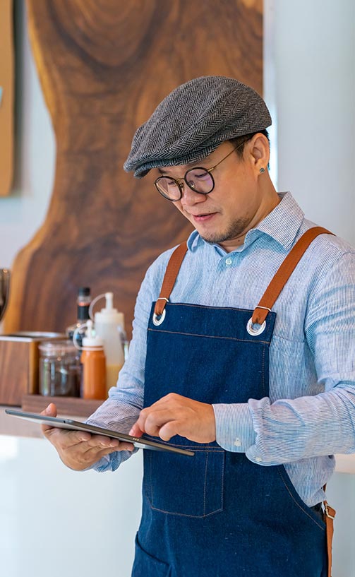 Male store owner checking his website.