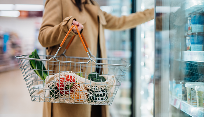 Woman at store aisle selecting products