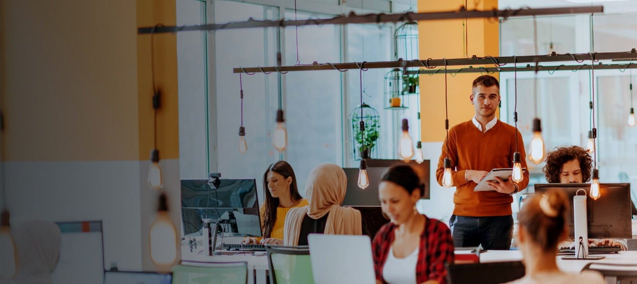 man standing in busy office