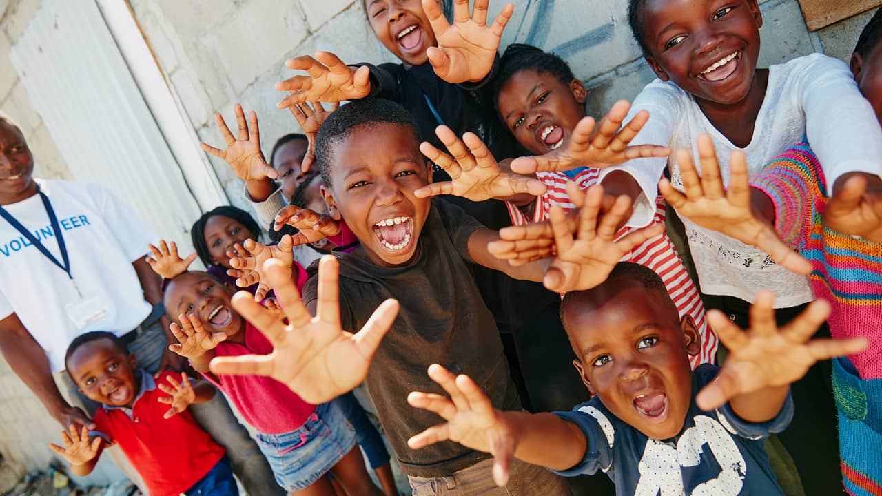 happy children cheering with raised hands