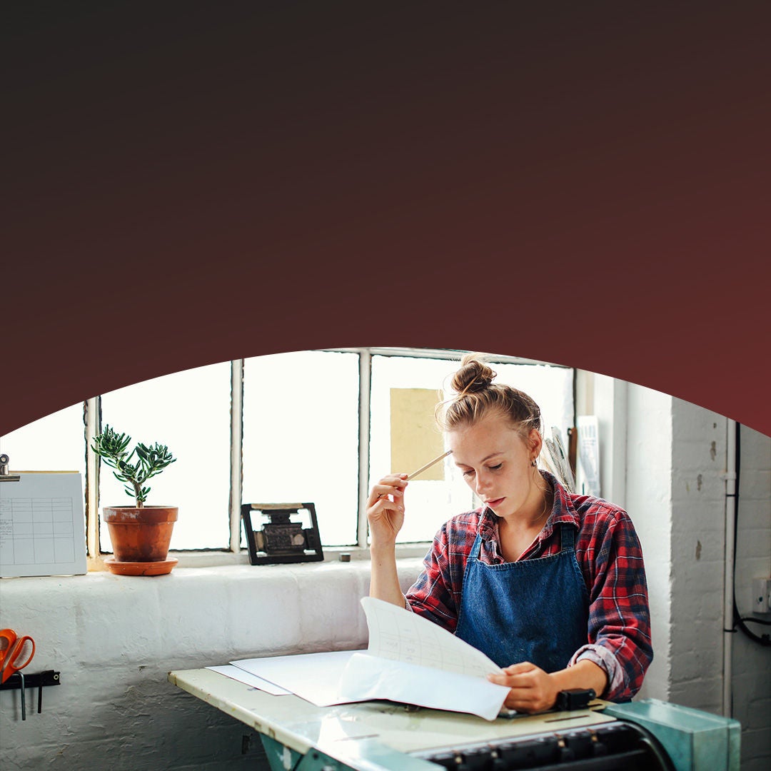 Woman thinking of solutions while looking at paper documents.